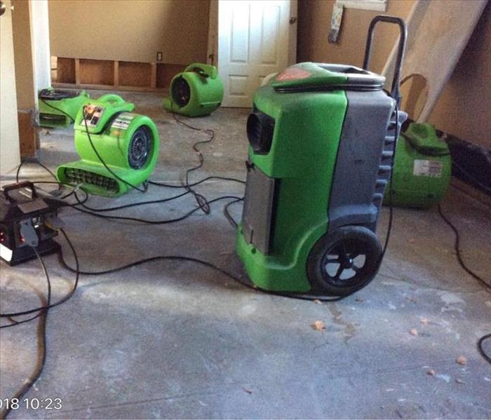 Living room with air movers and dehumidifiers 