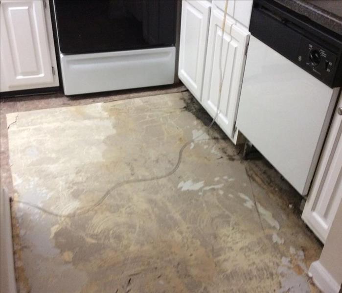 Flooring that was ripped up after a dishwasher overflowed