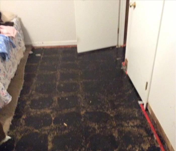 The floor of a bedroom that was damaged after a pipe burst