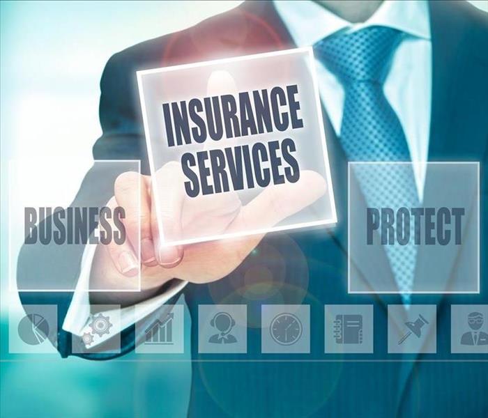 Man pushing an "insurance services" button